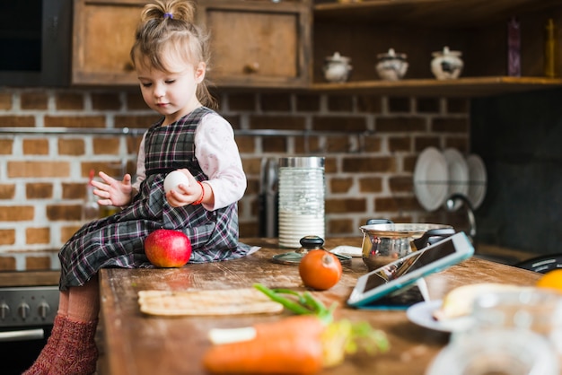 Free photo cute girl with egg and apple