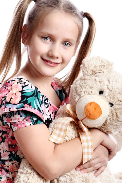 Cute girl with her teddy bear