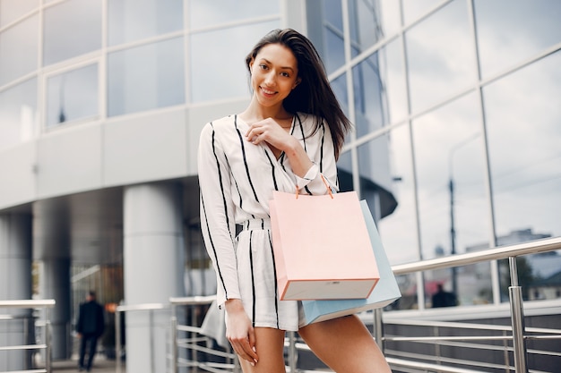 Free photo cute girl with shopping bag in a city