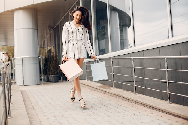 Cute girl with shopping bag in a city