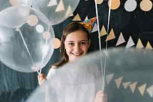 Free photo cute girl with white balloons