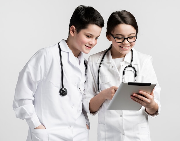 Cute girl and young boy dressed up as doctors