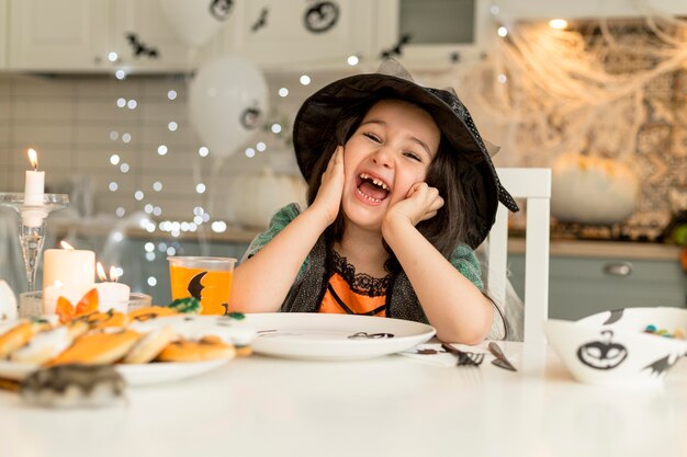 Cute and happy girl with witch costume