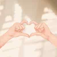 Free photo cute heart hand gesture social media post