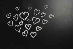 Free photo cute hearts on blackboard