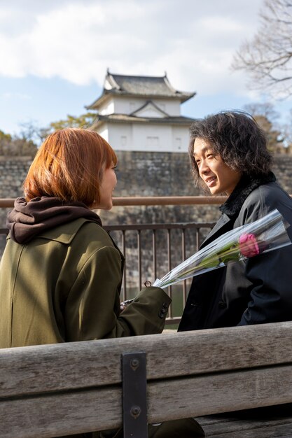 Cute japanese couple out on a date with rose flower