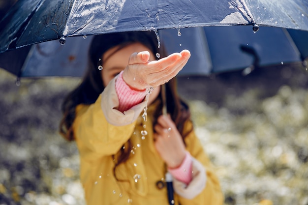 Cute kid plaiyng on a rainy day