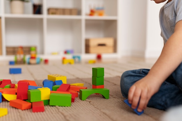 Free Photo cute kid playing with wooden toys