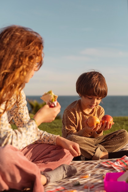 Cute kids eating outdoors