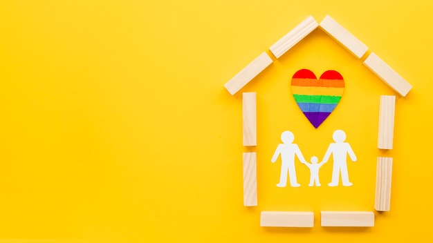 Free photo cute lgbt family concept arrangement on yellow background with copy space