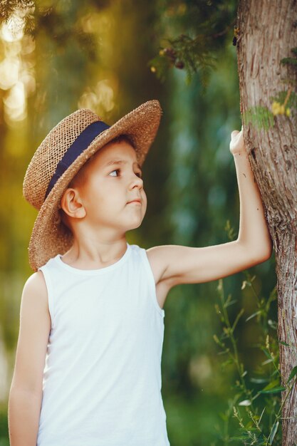 Cute little boy in a hat spend time in a summer park