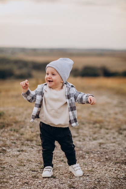 Free photo cute little boy having fun in field