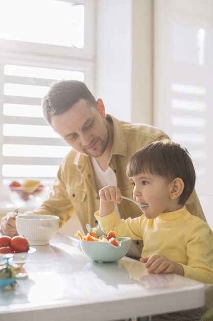 Cute little child and his father eating