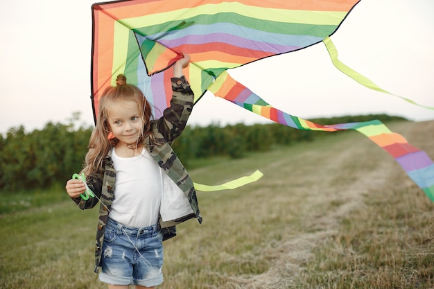 Cute little child in a summer field with a Kite