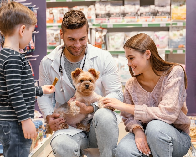 Cute little dog at the pet shop with owner