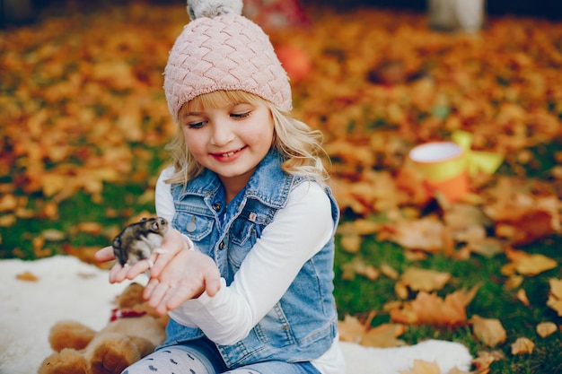 Free Photo cute little girl in a autumn park