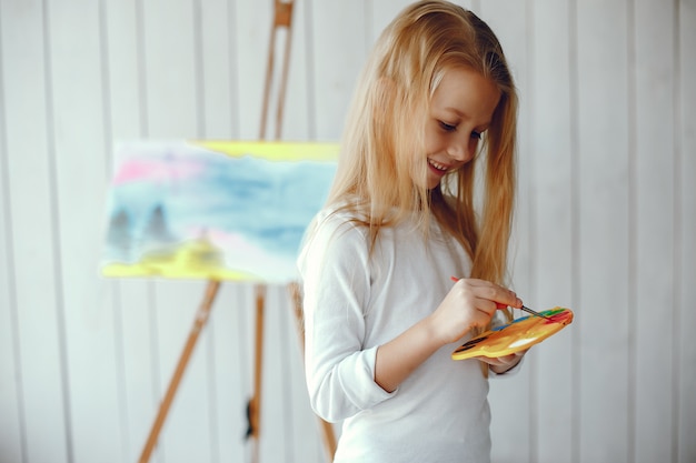 Cute little girl drawing in a studio