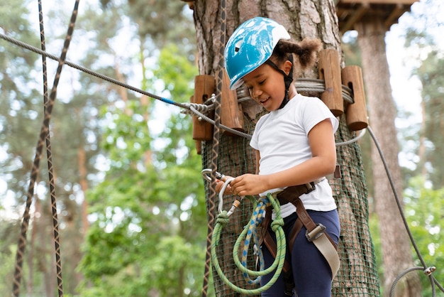 Cute little girl having fun at an adventure park