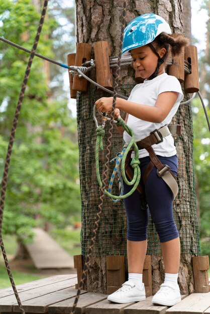 Cute little girl having fun at an adventure park