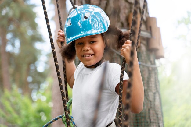 Cute little girl having fun at an adventure park