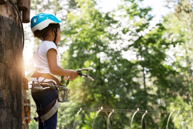 Cute little girl having fun at an adventure park