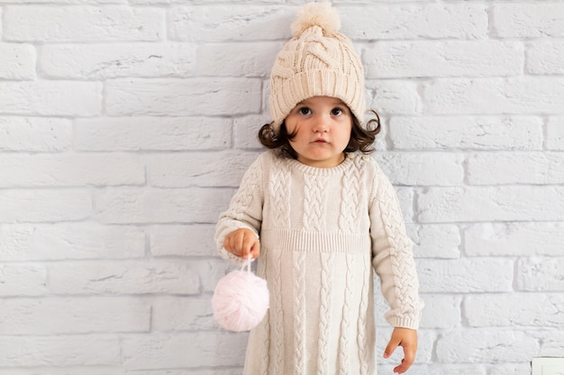 Free photo cute little girl holding a christmas globe