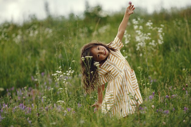 Cute little girl playing in a summer field