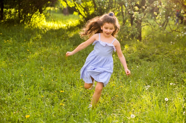 Cute little girl running in garden