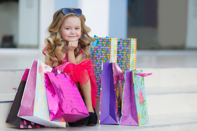 cute little girl shopping outdoors