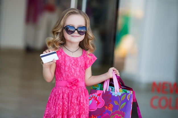 Free Photo cute little girl shopping outdoors