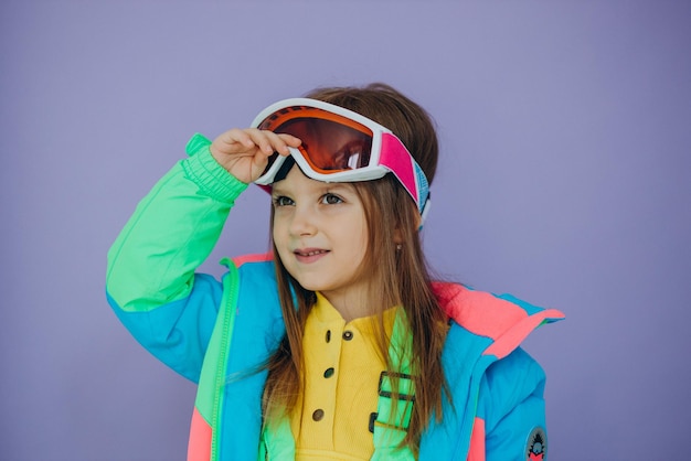 Free Photo cute little girl wearing ski wear isolated in studio