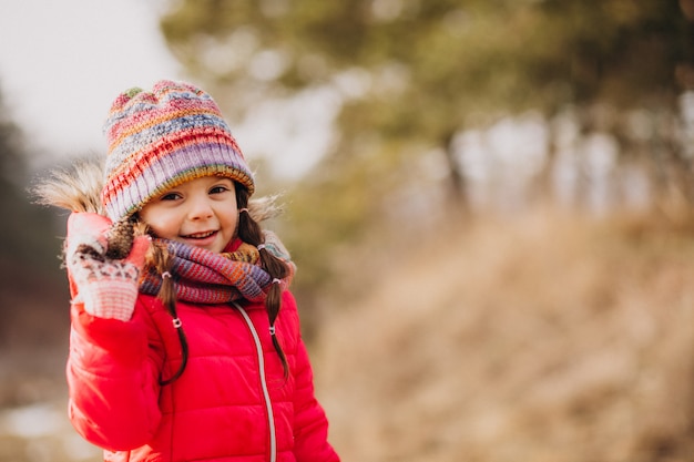 Free Photo cute little girl in a winter forest