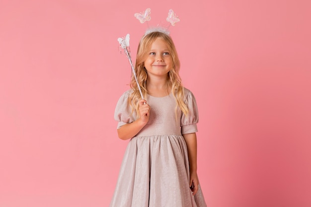 Cute little girl with wand and costume