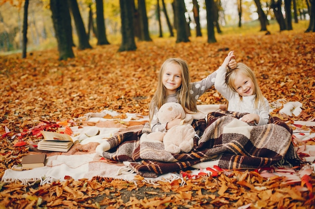 Cute little girls in a autumn park