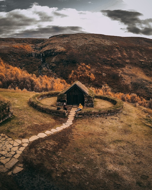 Cute little hut with stone pathway on top of a hill