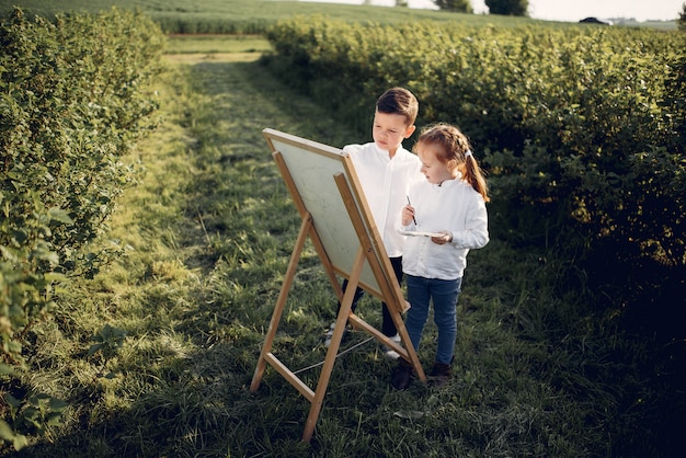 Free Photo cute little kids painting in a park