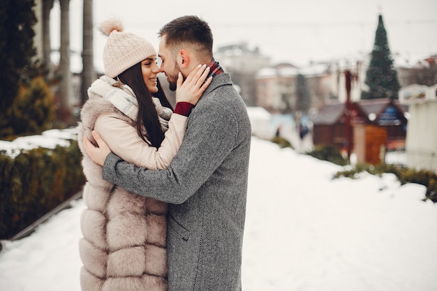 Cute and loving couple in a winter city