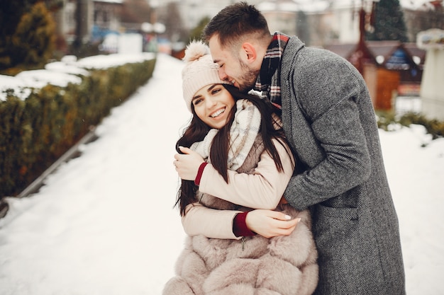 Cute and loving couple in a winter city