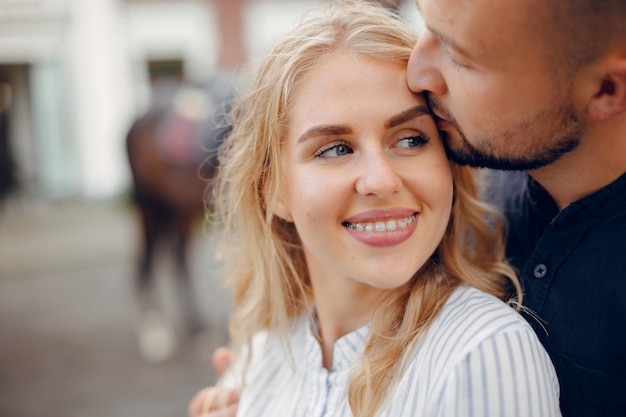 Free photo cute loving couple with horse on ranch