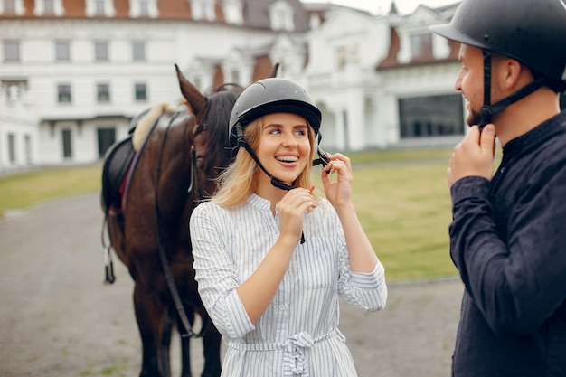 Cute loving couple with horse on ranch