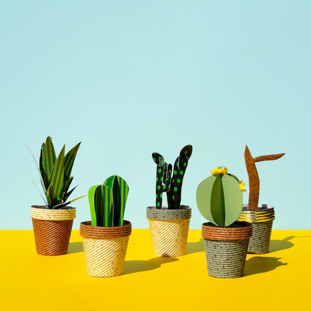 Cute paper cut style of artificial cacti and copy space background