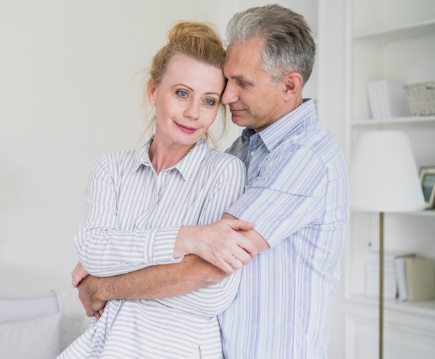 Cute senior couple holding each other