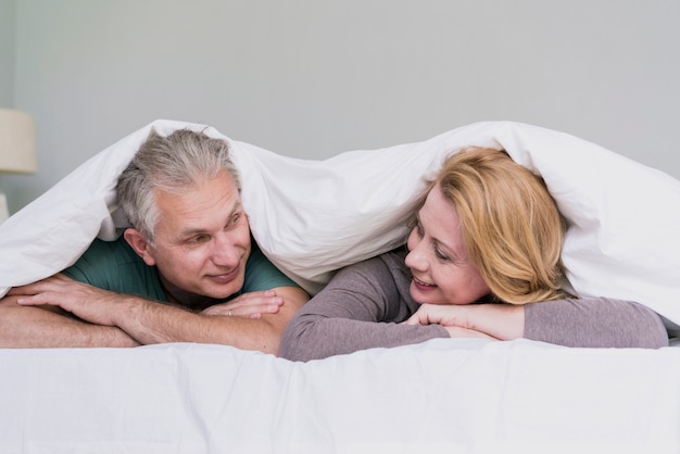 Cute senior man and woman looking at each other