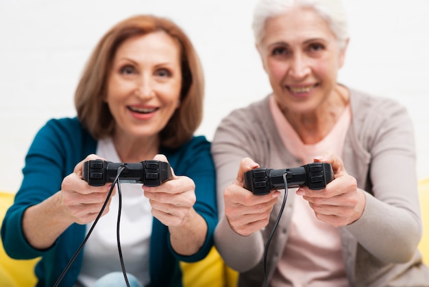 Cute senior women playing video games