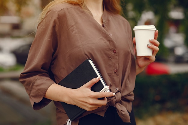 Cute student working in a park and use the notebook