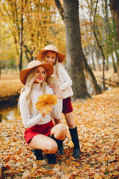 Cute and stylish family in a autumn park