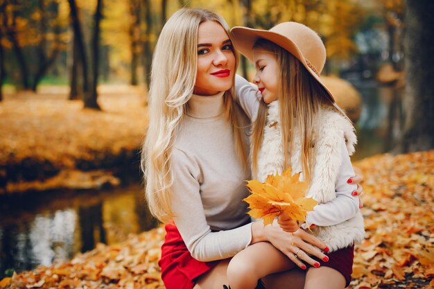 Cute and stylish family in a autumn park