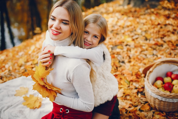 Free photo cute and stylish family in a autumn park