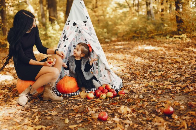 Cute and stylish family in a autumn park