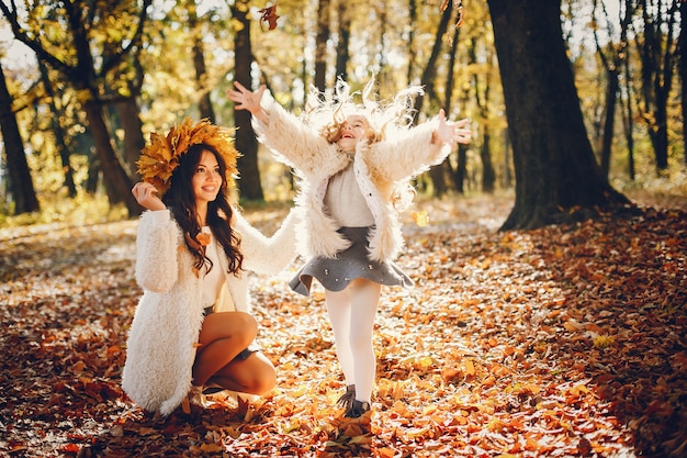 Cute and stylish family in a autumn park